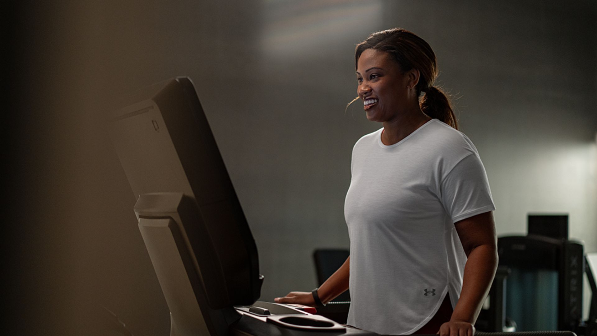 Lady on treadmil smiling